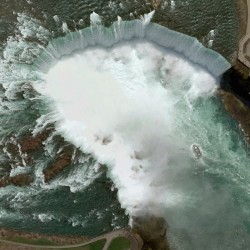 The frothing water below Niagara Falls dominates this image of the iconic waterfalls on the Cana ...