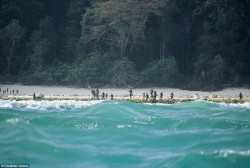 the Sentinelese hold javelins as they see outsiders approaching. – Album on Imgur