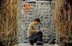 An engineer checks communication cables in the Media Gateway (MGW) lab simulating translation be ...