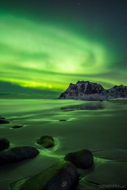 The Aurora Borealis lighting up Uttakleiv beach in Norway