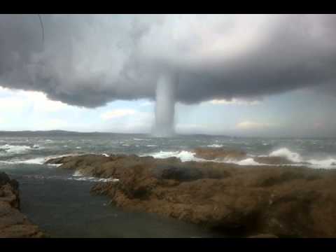 A waterspout is an intense columnar vortex that occurs over a body of water. They most commonly appear as funnel-shaped clouds connected to a cumuliform or cumulonimbus cloud. Only the strongest versions that spawn from mesocyclones (like land-based t ...