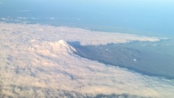 A Mountain cutting through the clouds