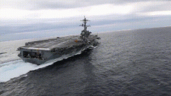 Aircraft carrier performing a high speed turn