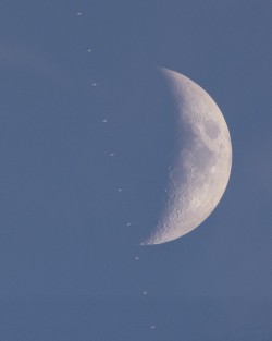 The ISS crossing in front of crescent moon during an uncommon daytime lunar transit.