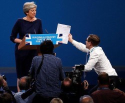 Prankster Simon Brodkin hands May P45 during conference speech | Politics | The Guardian