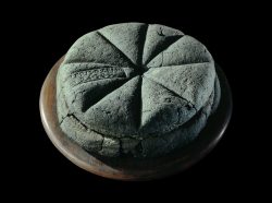 A preserved bread from Pompeii (79 AD). It has a bakers stamp which marked individual loaves tha ...