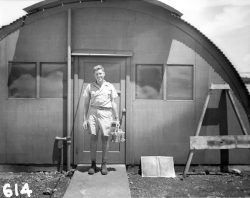 Physicist Harold Agnew smiles while holding the plutonium core of the fat man bomb that would la ...