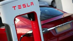 A Tesla car is charged at a Tesla dealership in West Drayton, just outside London, Britain, Febr ...