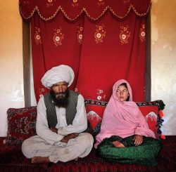 An 11-year old girl in Afghanistan sits beside her fiancé, estimated to be in his forties, at th ...