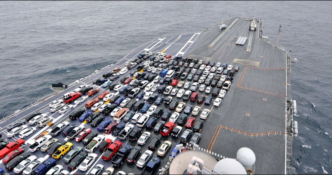 The USS Ronald Reagan transporting the vehicles of it’s crew while changing homeports.