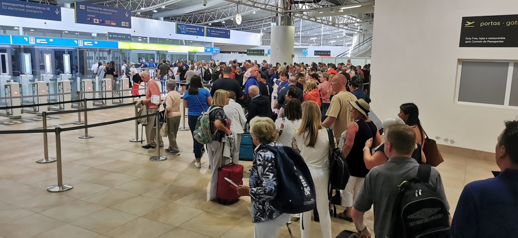 Queue at Faro Airport passport control for UK passports. EU passports on the left (that’s  ...