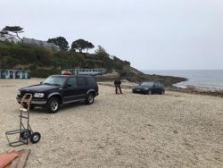 Idiots get BMW stuck on beach because they did not want to carry kayak