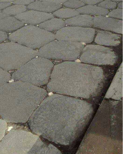 White reflective stones in a patterned Roman road used to light the route at night time. Roman t ...