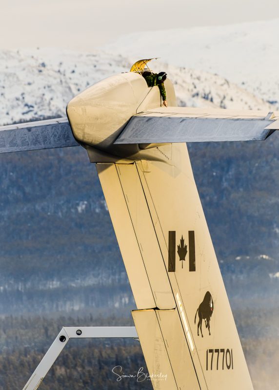 Frosty Friday. A crew member inspects the upper surface of the horizontal stabilizer as Air Nort ...