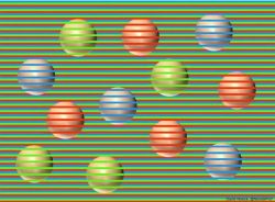 The balls behind the horizontal lines are all the same color.

This is called the Munker illusion.