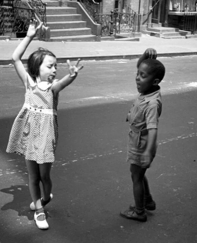 Two little kids dancing on the streets of New York City, c. 1940.