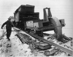A German railway plough ripping up Soviet railway track during a retreat. Schwellenpflugs (Sleep ...
