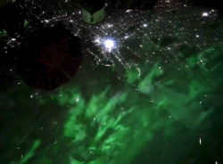 Amazing footage taken by Don Pettit from the ISS shows an aurora above city lights. The location ...